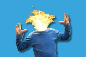 un homme dont la tête prend feu tellement il est surmené par le travail