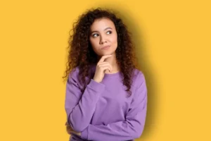 une femme se questionnant sur ses raisons pour lesquelles elle devrait faire un bilan de compétences sur Le Havre